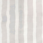 Grasscloth Wallpaper close up with bold watercolor stripes in greige and white. 