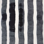 Grasscloth Wallpaper close up with bold watercolor stripes in black and white. 
