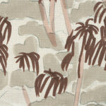 Close-up of fabric in a painterly palm tree print in shades of pink, brown and blue on a white field.