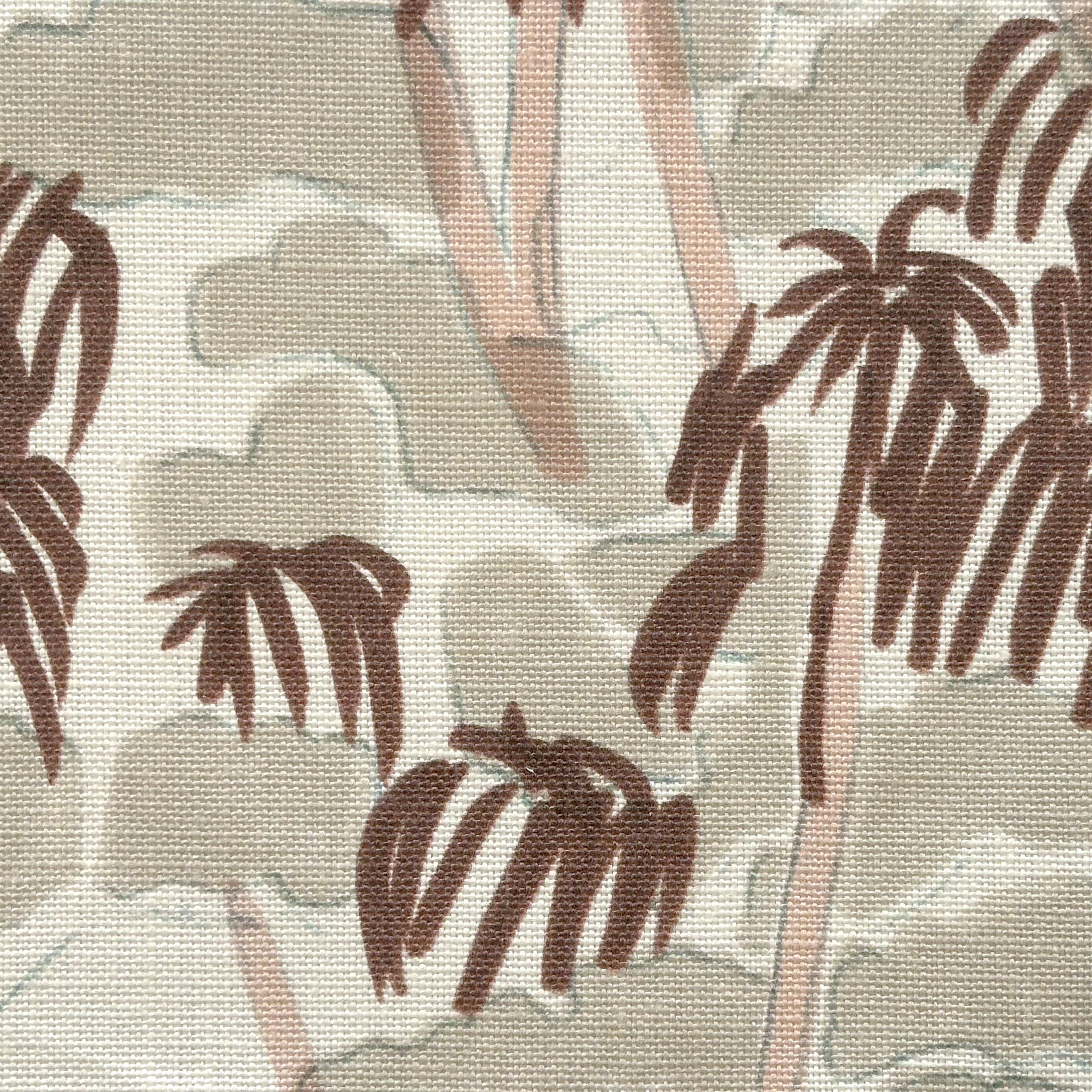 Close-up of fabric in a painterly palm tree print in shades of pink, brown and blue on a white field.