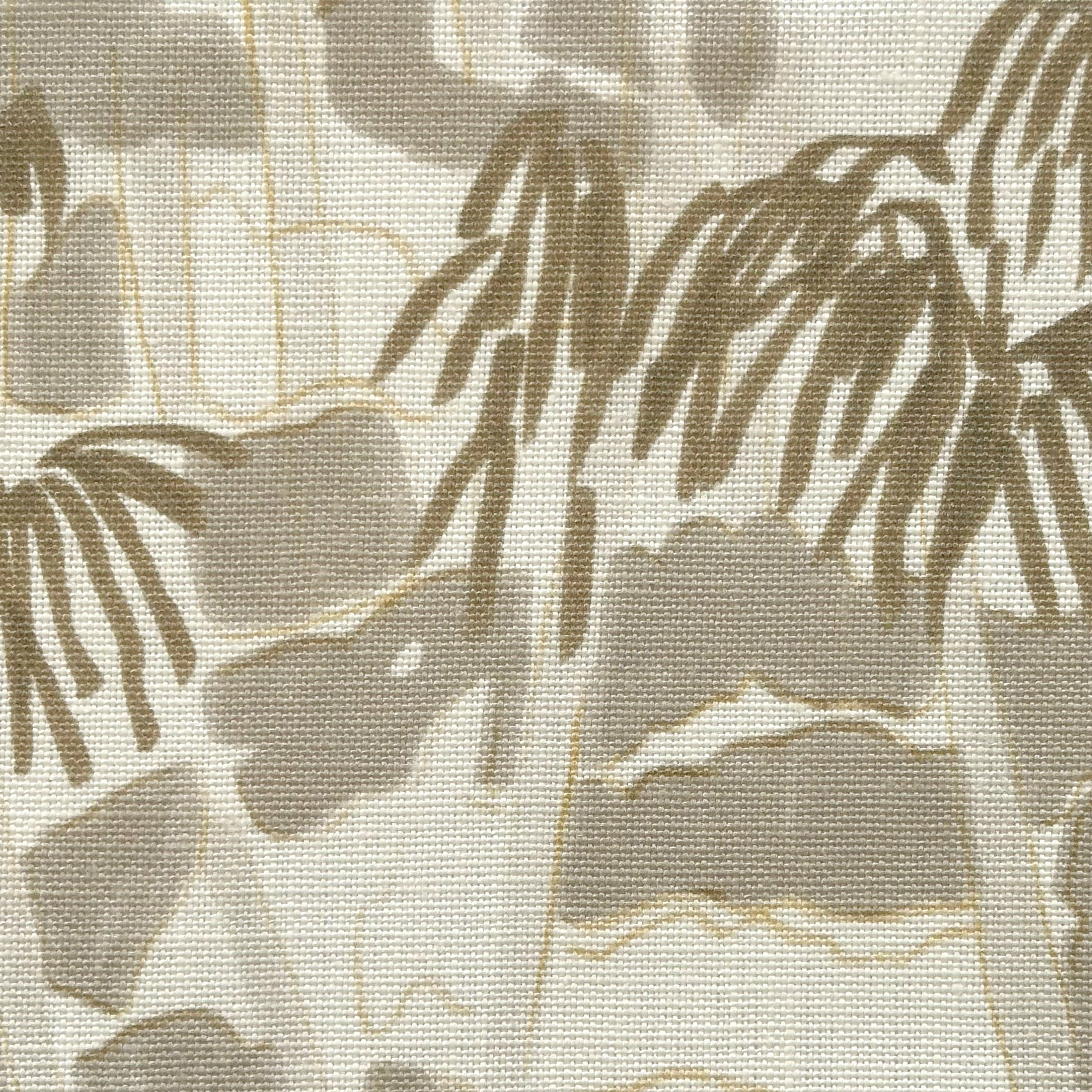 Close-up of fabric in a painterly palm tree print in shades of gray and gold on a white field.