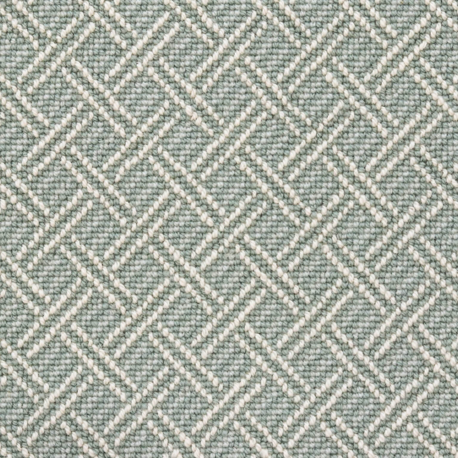 Broadloom carpet with ivory double line lattice on a seafoam blue field. 