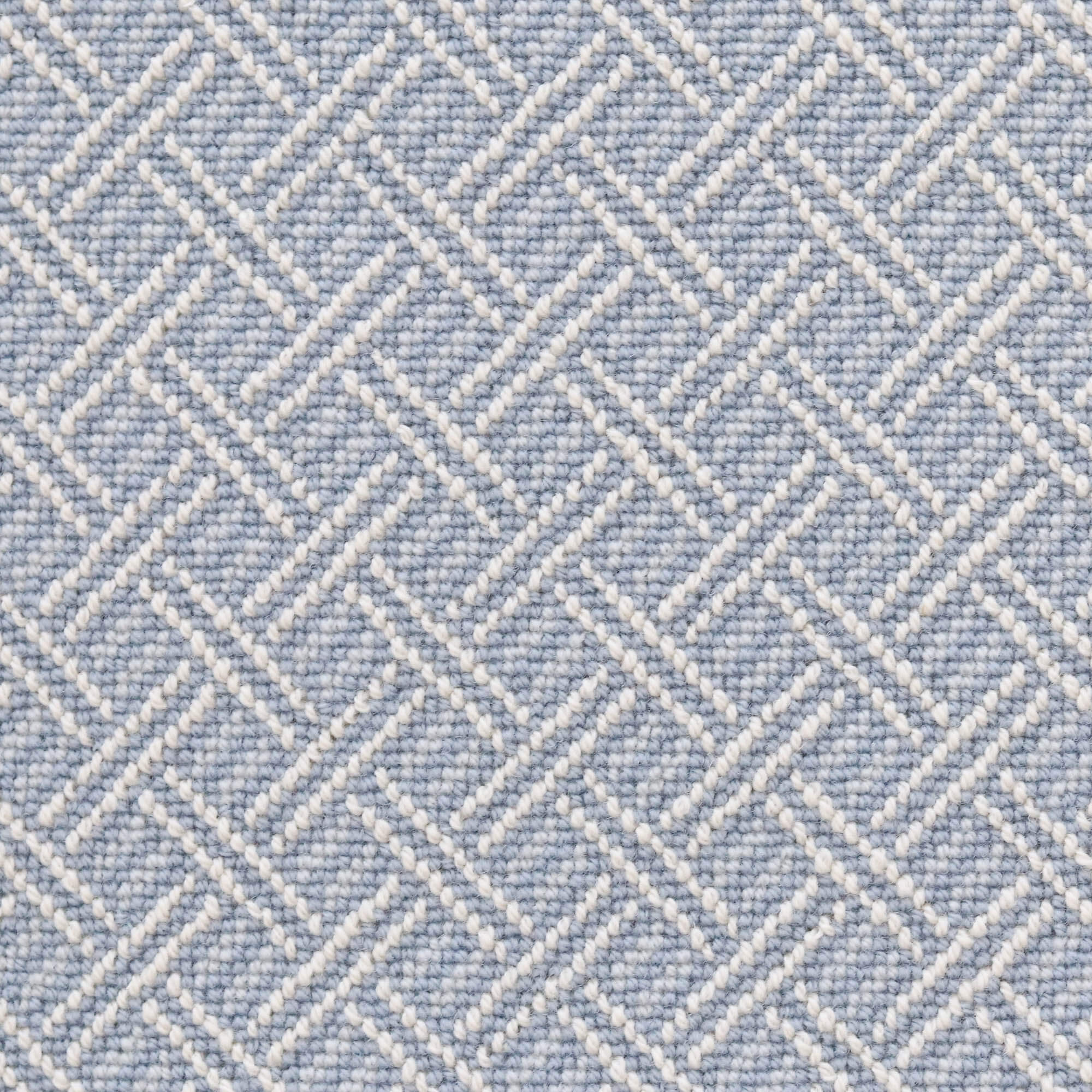 Broadloom carpet with ivory double line lattice on a sky blue field. 