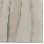 Detail of a handmade wallpaper swatch with an irregular combed stripe pattern in charcoal on a greige field.