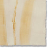 Detail of a handmade wallpaper swatch with an irregular combed stripe pattern in ochre on a tan field.