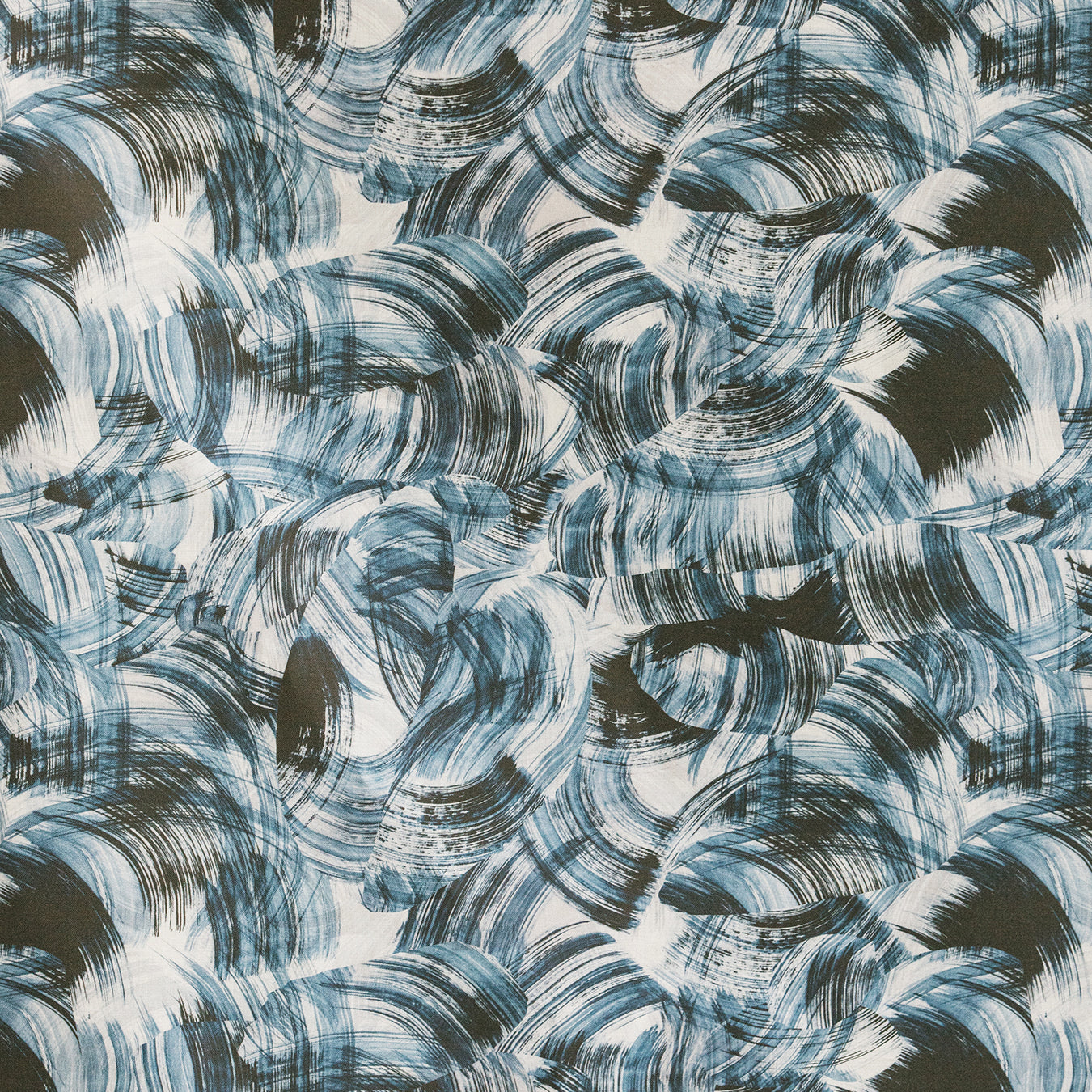 Detail of fabric in an absract paint swatch print in black and navy on a white field.
