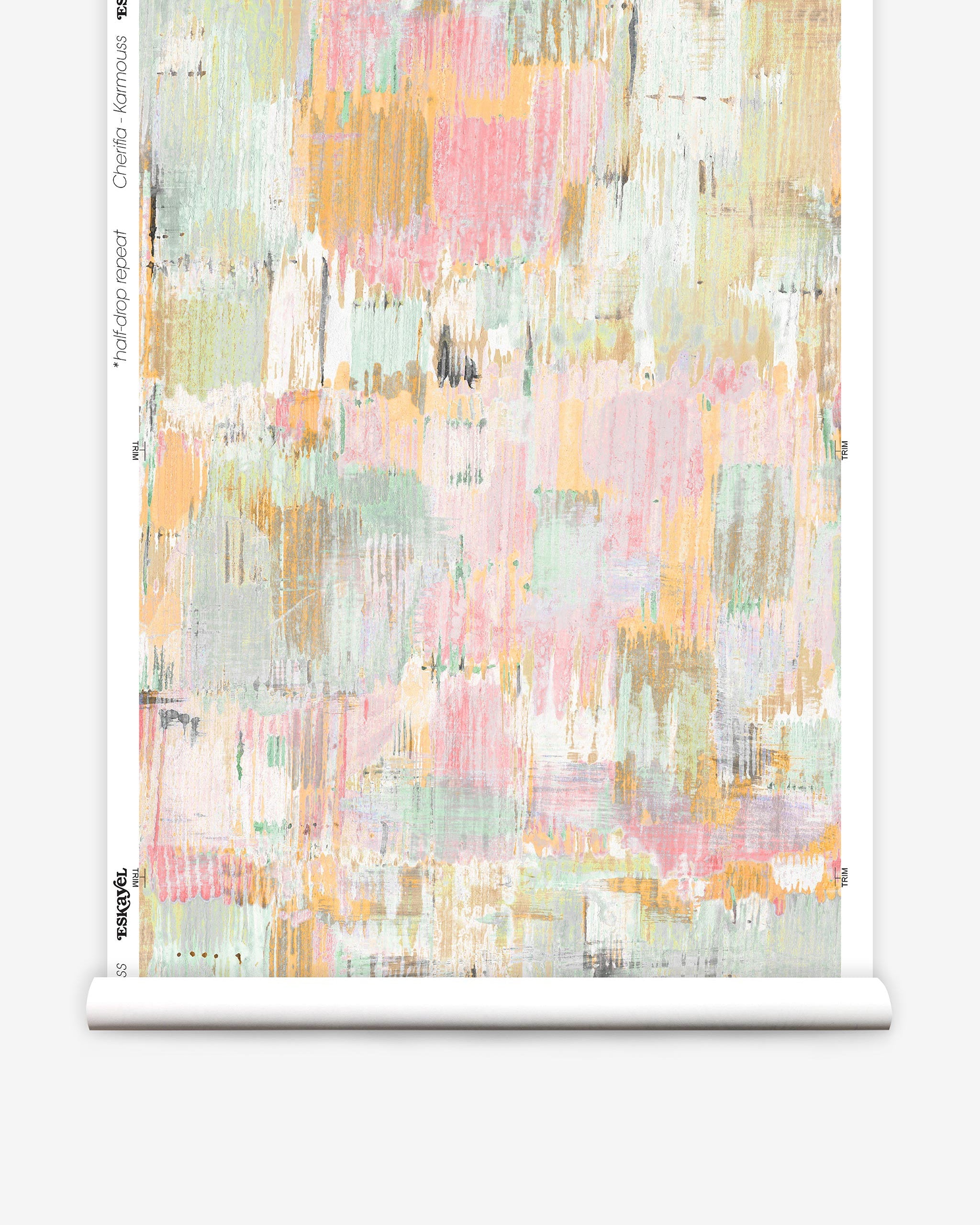 Partially unrolled wallpaper yardage in a watercolor textural print in shades of pink, green, yellow and white.