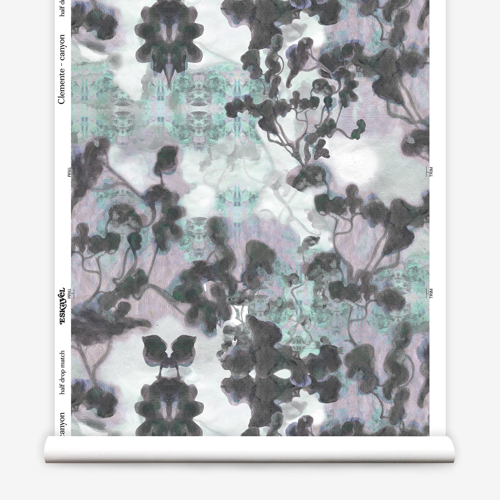 Partially unrolled wallpaper yardage in a watercolor tree print in gray, turquoise, purple and white.