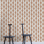 Two minimalist black chairs stand in front of a wall papered in a playful curvy stripe print in white, blue and brown.