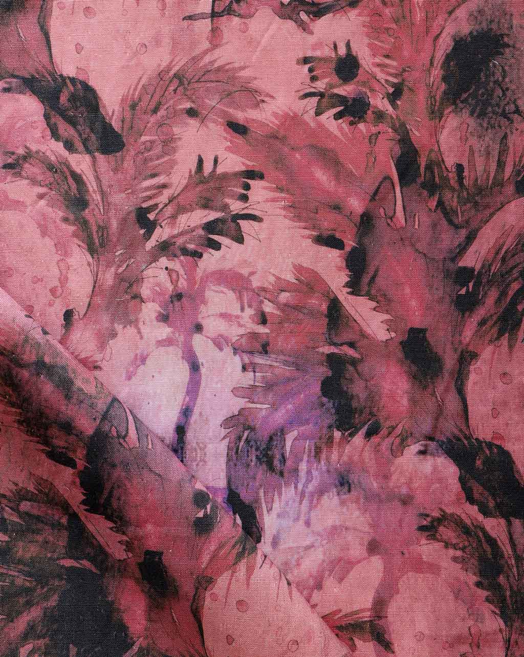 Detail of fabric in a painterly palm leaf print in shades of red, purple and gray.