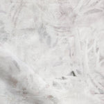 Detail of fabric in a watercolor painterly print in light gray on a cream field.