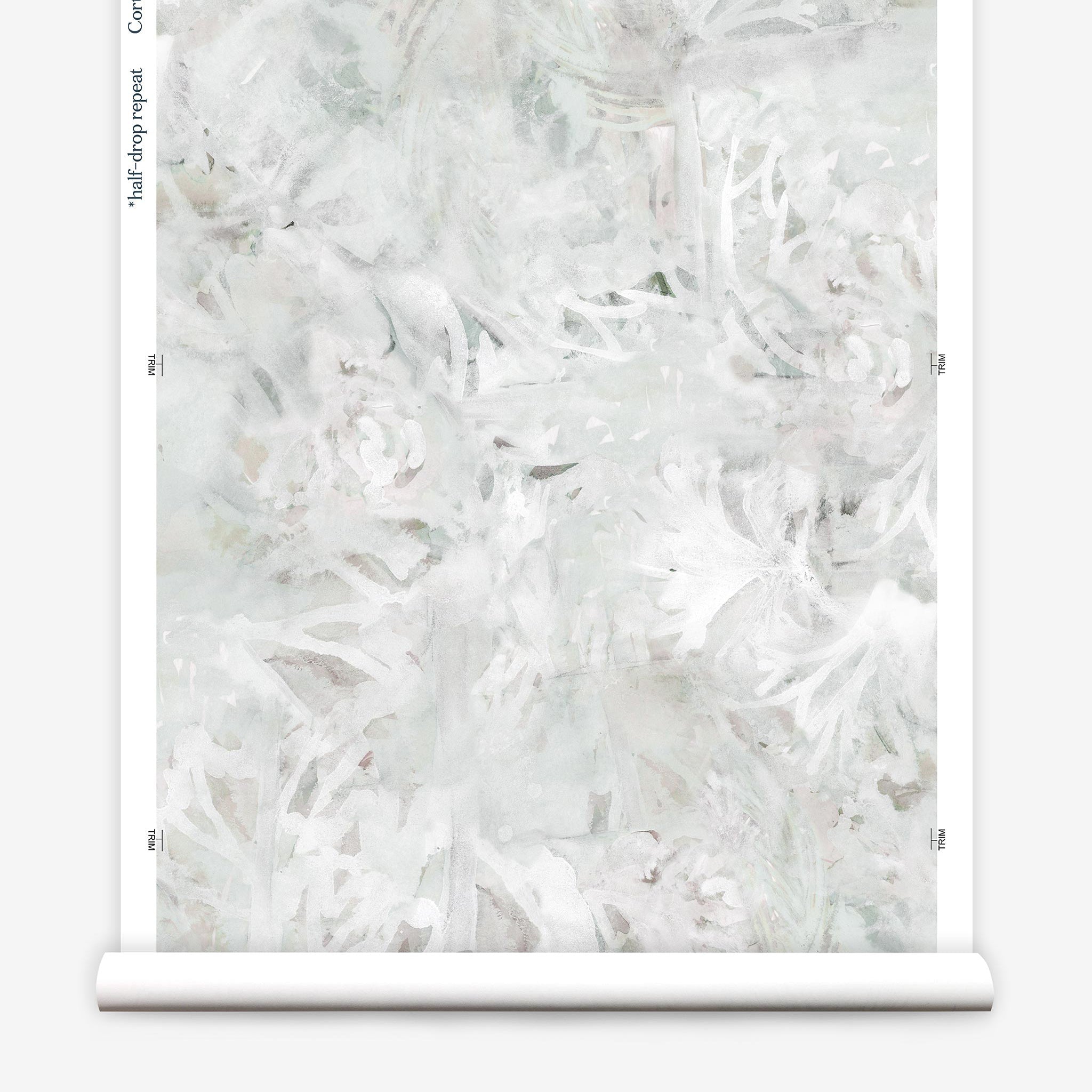 Partially unrolled wallpaper yardage in a watercolor painted print in shades of gray and white.