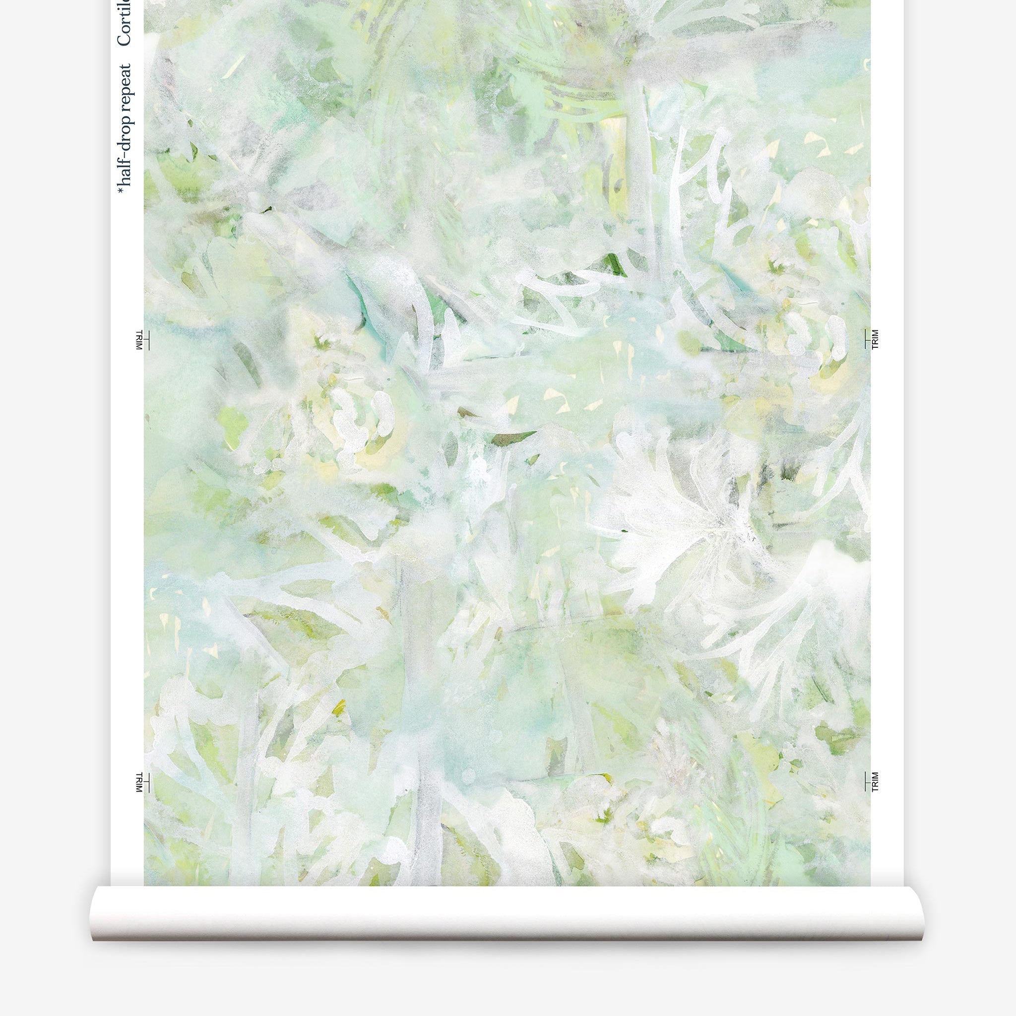 Partially unrolled wallpaper yardage in a watercolor painted print in shades of green, yellow and white.
