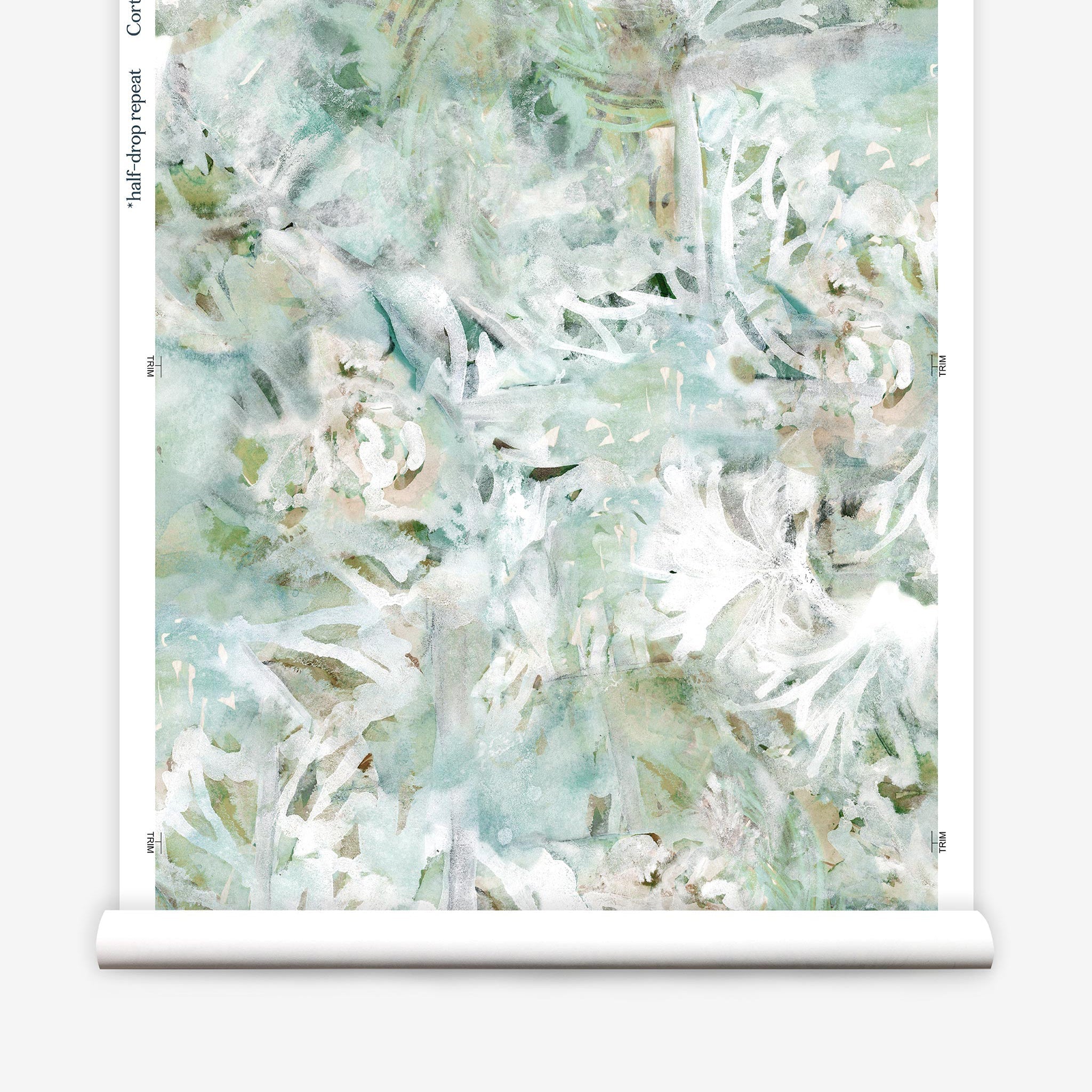 Partially unrolled wallpaper yardage in a watercolor painted print in shades of green, tan and white.