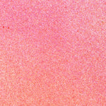 Close up of paint splatters in pink and orange.