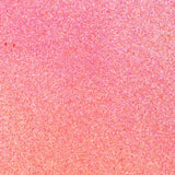Close up of paint splatters in pink and orange.