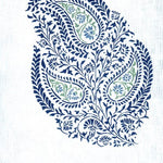 Detail of fabric in a botanical paisley in navy and green on a white field.