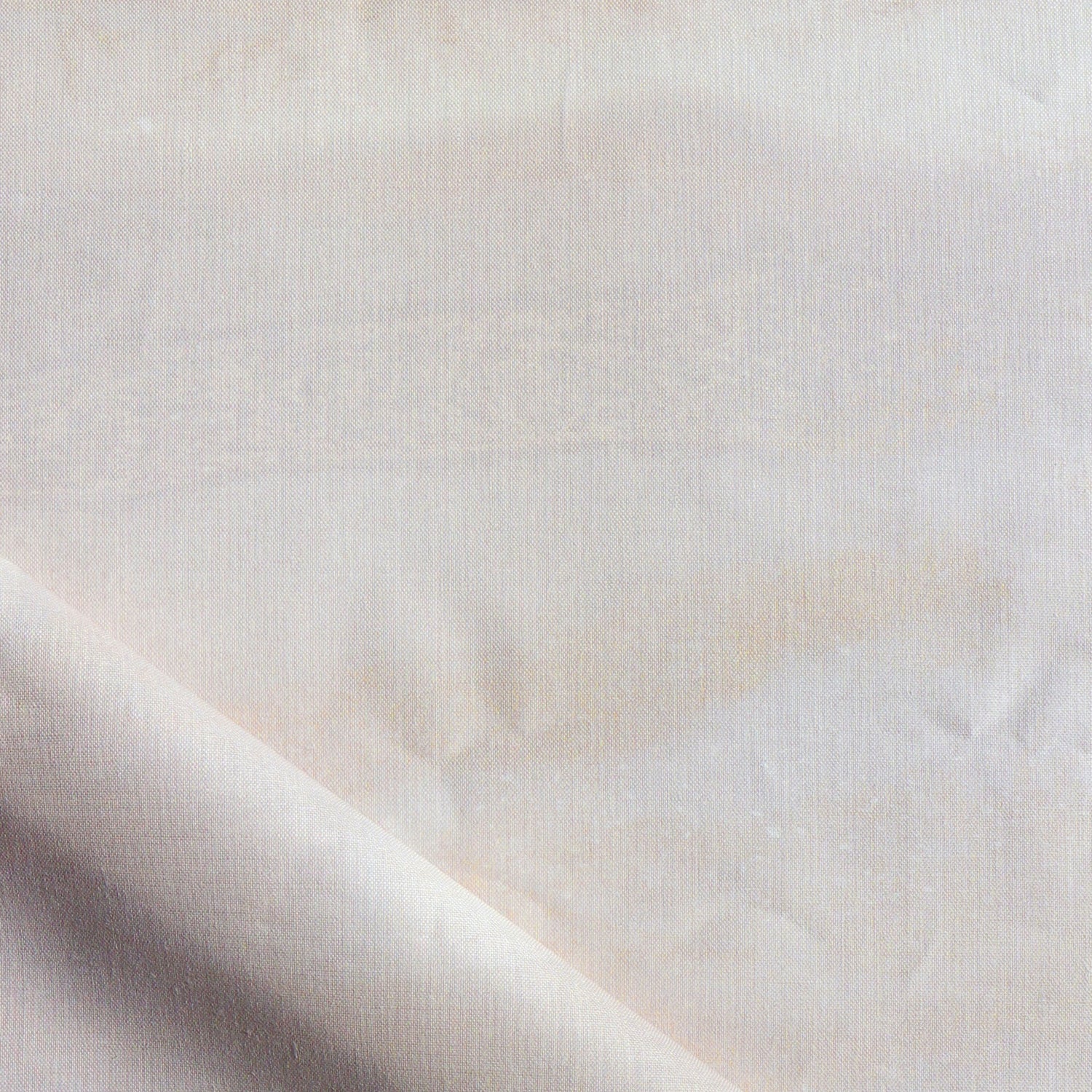 Close-up of a textured white fabric with a subtle pattern