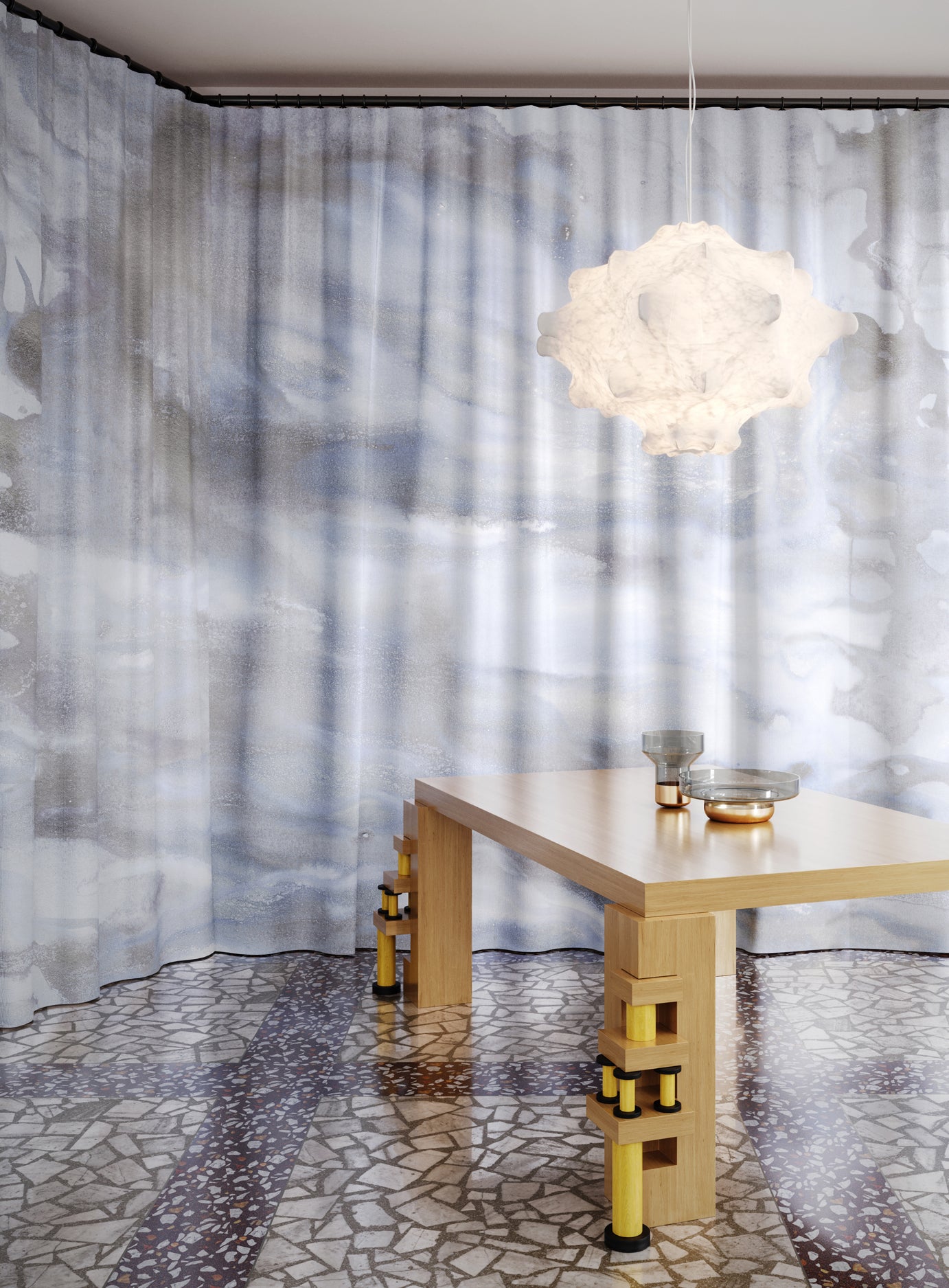 Modern interior with a light fixture, table, and abstract patterned curtain