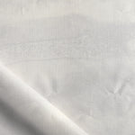 Close-up of white fabric with subtle texture