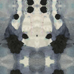 Close-up of wallpaper in a watercolor ink blot print in shades of charcoal and gray on a tan field.