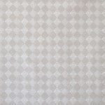 Detail of fabric in a textural diamond print in cream.