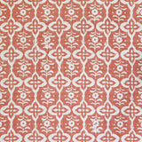 Detail of fabric in a floral grid print in cream on a coral field.