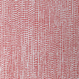Detail of fabric in a painterly dotted print in coral on a white field.