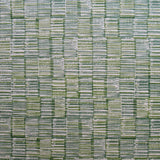 Detail of fabric in a textural grid print in blue and green on a light gray field.
