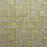 Detail of fabric in a textural grid print in mustard and tan on a light gray field.