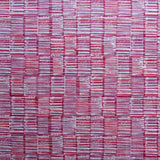 Detail of fabric in a textural grid print in pink and purple on a light gray field.