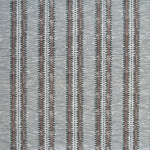 Detail of fabric in a dense tribal stripe pattern in shades of greige, brown and charcoal.