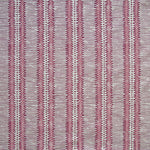Detail of fabric in a dense tribal stripe pattern in shades of gray, pink and maroon.