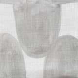 Close-up of fabric in an abstract scalloped print in gray on a white field.