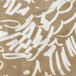 Close-up of fabric in a painterly wave print in white on a tan field.