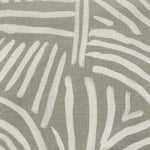 Close-up of fabric in an abstract linear print in white on a sage field.