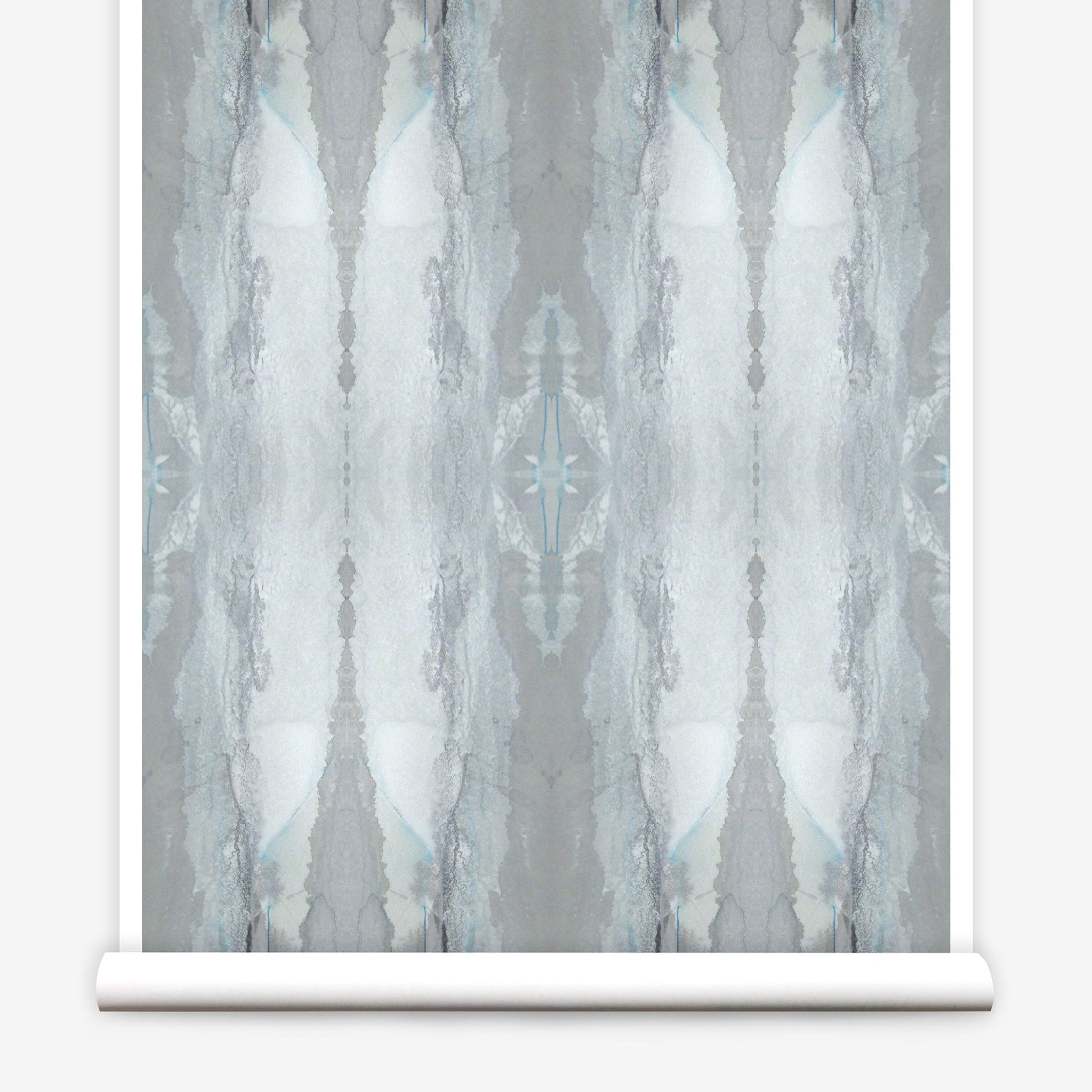 Partially unrolled wallpaper yardage in a watercolor textural print in shades of gray and blue-gray.