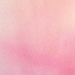 Detail of fabric in an abstract ombré paint splatter print in shades of pink, coral and white.
