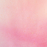 Detail of fabric in an abstract ombré paint splatter print in shades of pink, coral and white.