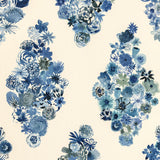 Detail of wallpaper in a painterly floral print in shades of blue and navy on a cream field.