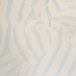 Detail of wallpaper in a playful broken stripe print in light blue on a cream field.