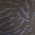 Detail of wallpaper in a playful broken stripe print in black on a navy field.