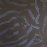 Detail of wallpaper in a playful broken stripe print in black on a navy field.