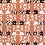 Detail of wallpaper in a linear floral print in red, white and black on an orange field.