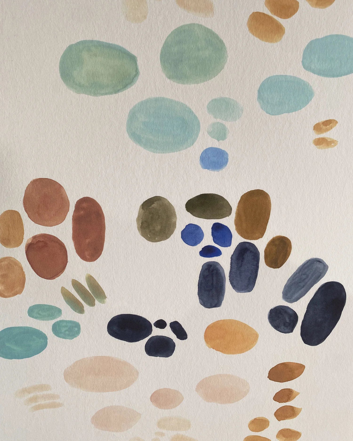 Close-up of wallpaper in an abstract painterly print in shades of turquoise, blue and orange on a white field.