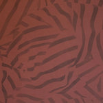 Detail of wallpaper in a playful broken stripe print in purple on a red field.