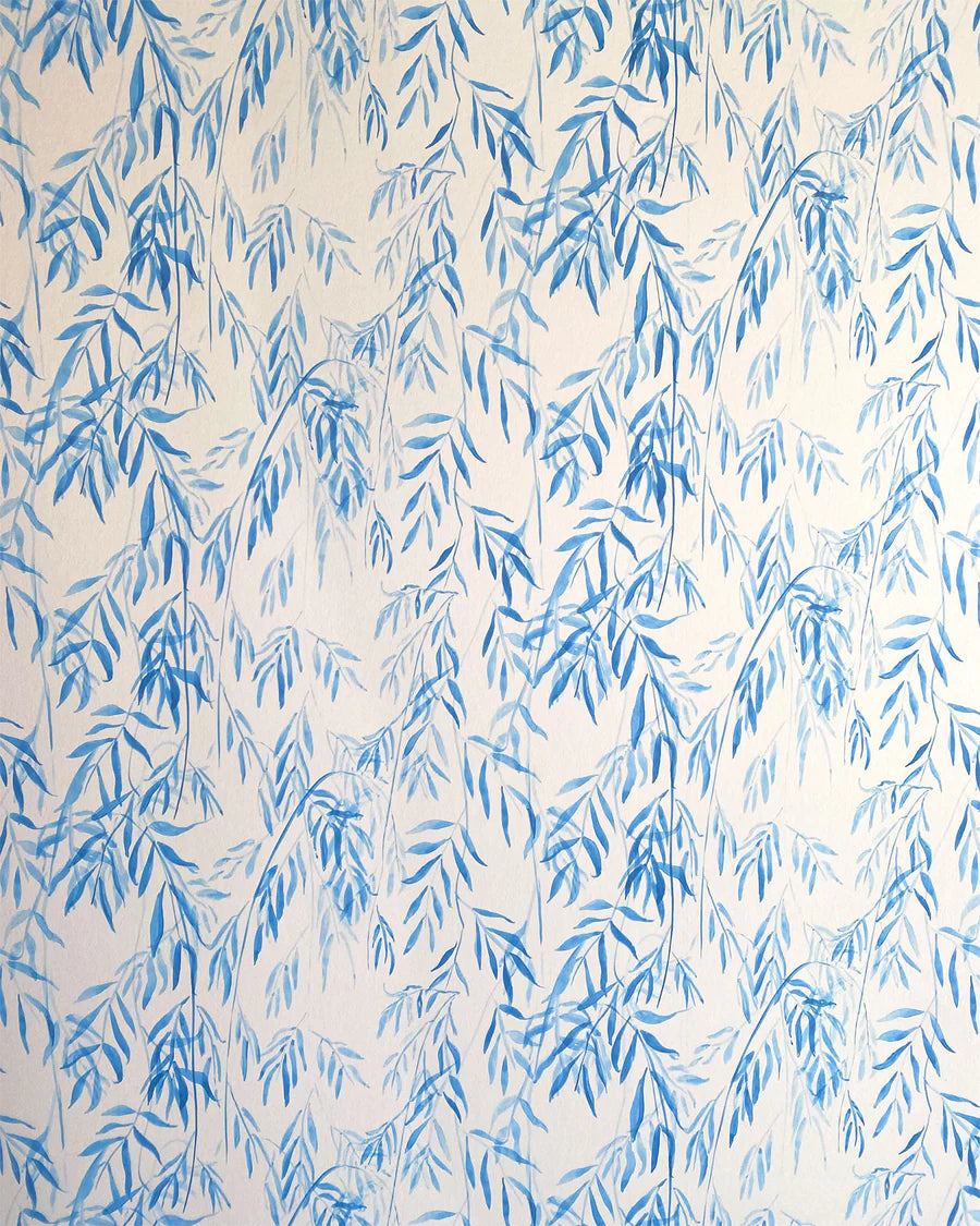 Detail of wallpaper in a painterly willow leaf print in blue on a white field.