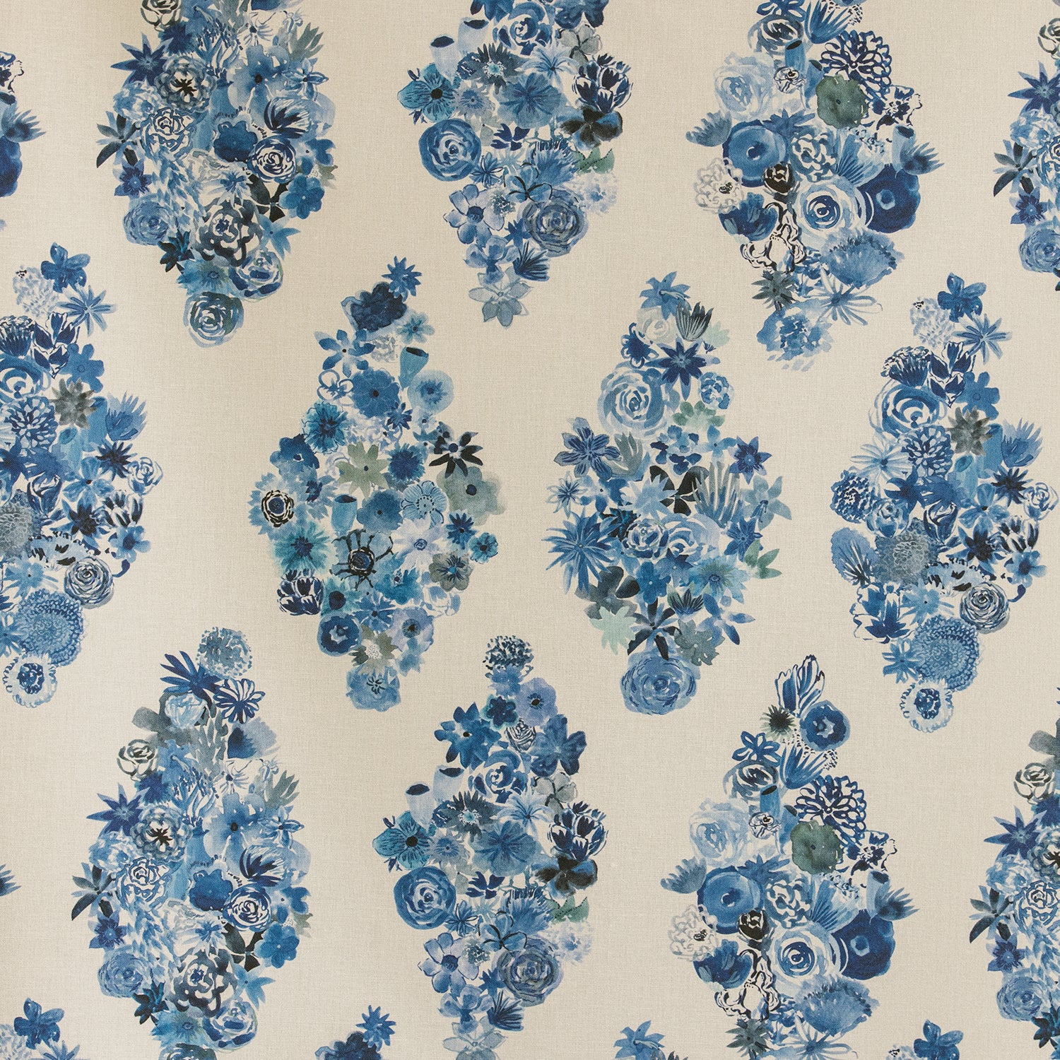 Detail of fabric in a painterly floral print in shades of blue and navy on a cream field.