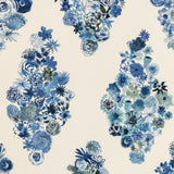 Detail of fabric in a painterly floral print in shades of blue and navy on a cream field.