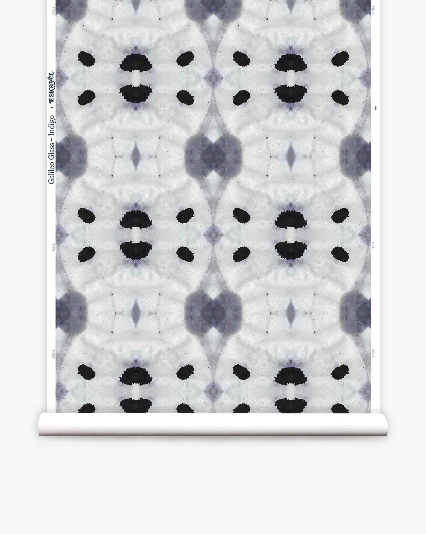 Partially unrolled wallpaper yardage in a watercolor ink blot print in shades of charcoal and black on a greige field.